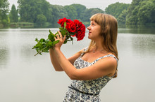 Young Lady By The Lake Holds A Roses