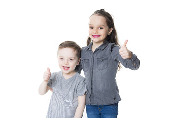 cute little boy and girl with his thumb up on the white background