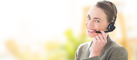 Wall Mural - Composite image of smiling businesswoman with headset 