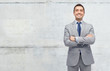 © Syda Productions - happy businessman in suit over concrete wall