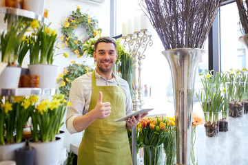 Poster - man with tablet pc computer at flower shop