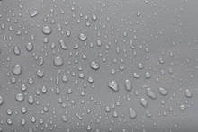 Dops Of Water On A Color Background. Gray