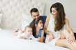 © BGStock72 - Family on the bed
