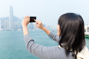 Wall Mural - Woman taking photo in Hong Kong