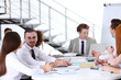 © Africa Studio - Young colleagues sitting at the business meeting in the office