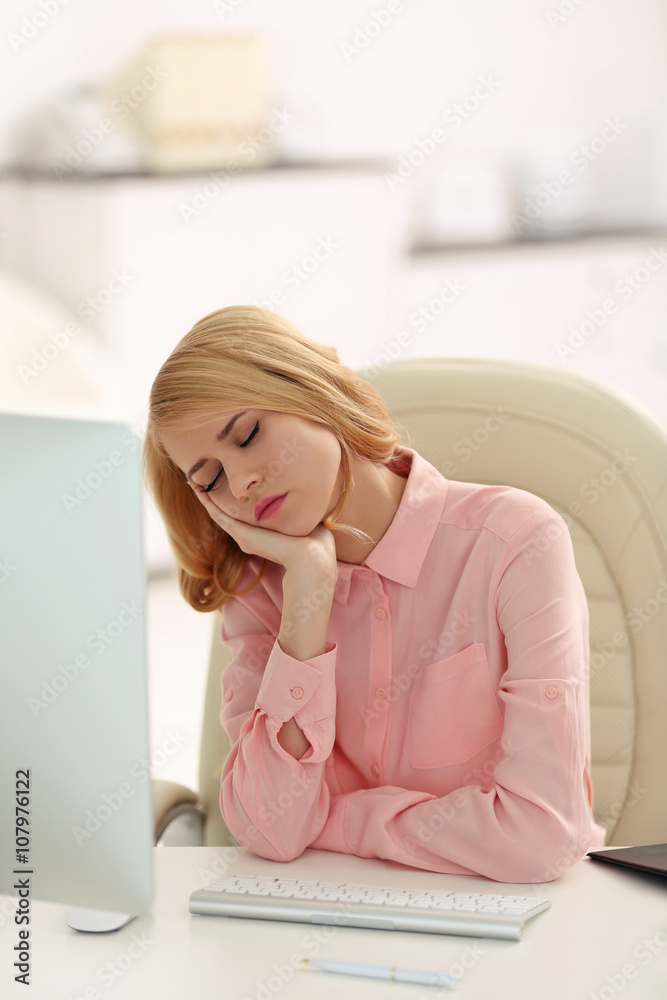 Tired woman at the computer in office
