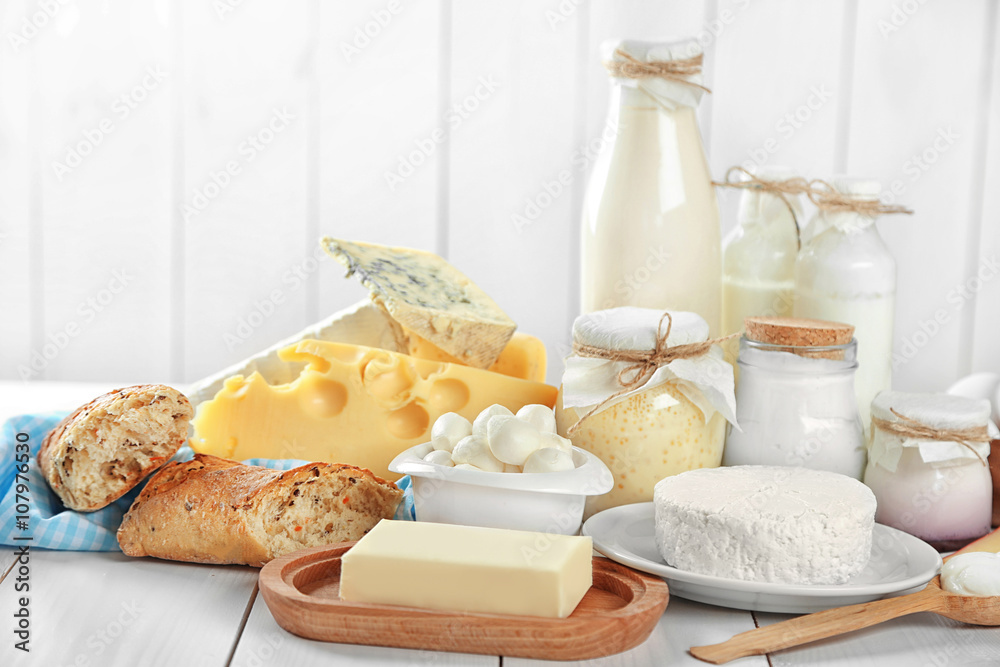 Set of fresh dairy products on white wooden table