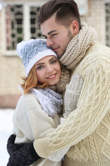 Wall Mural - Young couple embracing outdoors in winter