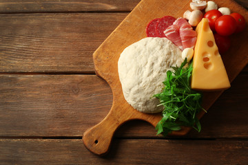 Sticker - Fresh dough and other different ingredients for pizza on wooden background