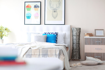 Sticker - Bedroom interior in light tones with white furniture and pictures on the wall