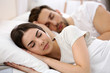 © Africa Studio - Young cute couple sleeping together in bed.