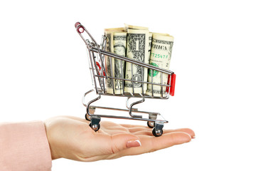 Poster - Woman holding supermarket trolley full of money, isolated on white