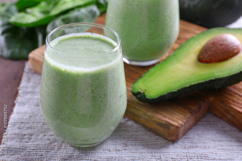 Avocado smoothie on wooden cutting board closeup