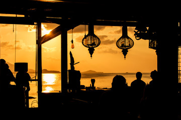 Wall Mural - people at bar sunset background