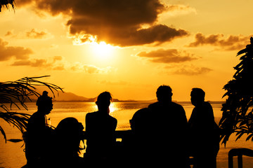 Wall Mural - Silhouette of people at bar sunset background