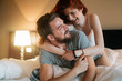 © NDABCREATIVITY - Happy couple in bed showing emotions