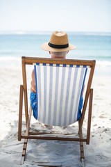 Wall Mural - Mature man relaxing on a deck chair