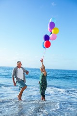 Wall Mural - Senior couple holding balloons 