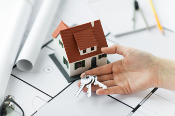 Poster - close up of hand with house keys and blueprint