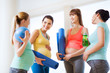 © Syda Productions - group of happy pregnant women talking in gym