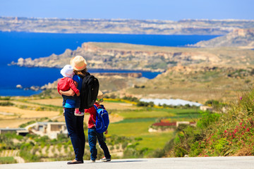 mother with two kids travel on scenic road