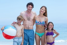 Cheerful Family In Swimwear Standing At Sea Shore