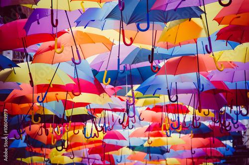 фотографія Colorful umbrellas hanging above the street