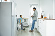 © Inti St Clair/Blend Images - Father and son talking in kitchen