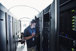 © Erik Isakson/Blend Images - Technician using digital tablet in server room