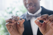 Close Up Of Groom Holding Wedding Rings