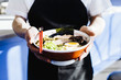 © Emily Suzanne McDonald/Blend Images - Chef holding bowl of ramen in restaurant