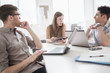 © JGI/Tom Grill/Blend Images - Business people using technology in office meeting
