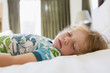 © Marc Romanelli/Blend Images - Boy sleeping on bed