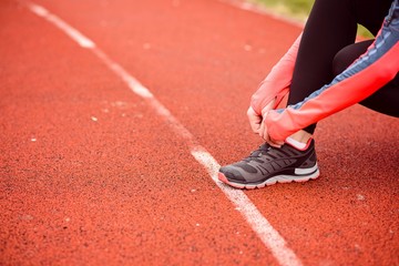 Poster - Woman runner tying her shoe