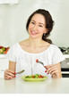 © Svetlana Fedoseeva - Woman making salad in kitchen. Healthy eating lifestyle concept.