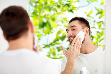 Poster - happy man applying shaving foam at bathroom mirror