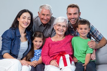 Wall Mural - Family giving a gift to grandmother 