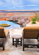 Infinity pool and lounge chairs with a view of endless desert