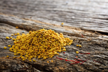 Wall Mural - Bee pollen pile set on old wooden surface