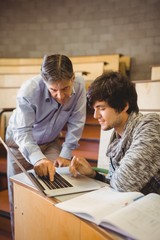 Professor helping a student in classroom