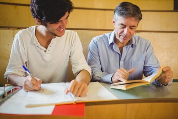 Professor assisting a student with his study