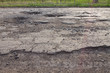 pits and potholes on asphalt road. The bad broken road