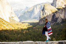 Woman Walking With American Flag Quilt At Yosemite National Park