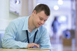 © Disability Images/Blend Images - Caucasian man with Down Syndrome using digital tablet in hospital