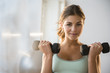 © JGI/Jamie Grill/Blend Images - Young woman exercise with weights