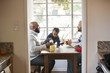© Sam Diephuis/Blend Images - Fathers and children sitting at table
