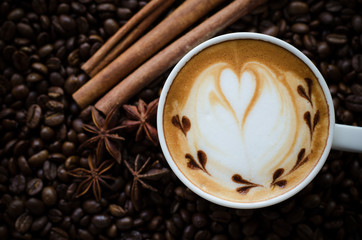 Wall Mural - latte art coffee on coffee beans background