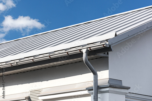Fotografia, Obraz gray metal roof with gutter and drainpipe