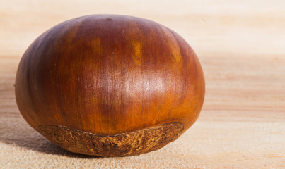 Fresh single chestnut on the wooden