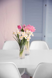 Fototapeta Tulipany - Beautiful tulips and irises on dinning table , indoors